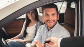 Young couple in their new car