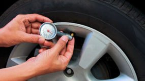 checking the tire pressure on a car