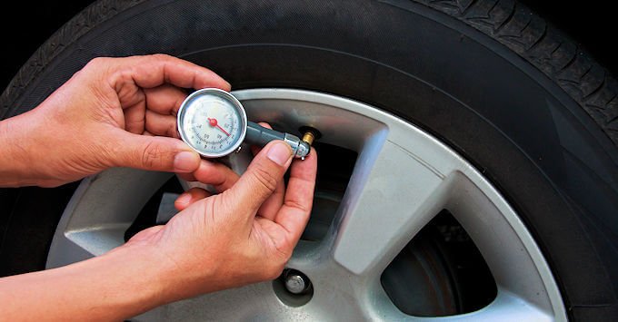 checking the tire pressure on a car