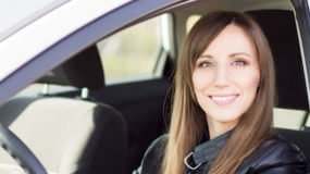 Young woman behind the wheel of her car